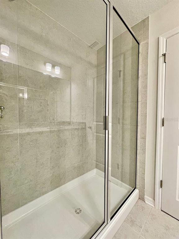 9689 Sweetwell Place Riverview, FL 33569 - Photo 20 of 33 a bathroom with a bathtub and a shower