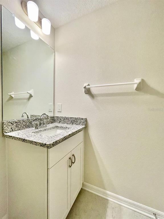 9689 Sweetwell Place Riverview, FL 33569 - Photo 23 of 33 a bathroom with a granite countertop sink and a mirror