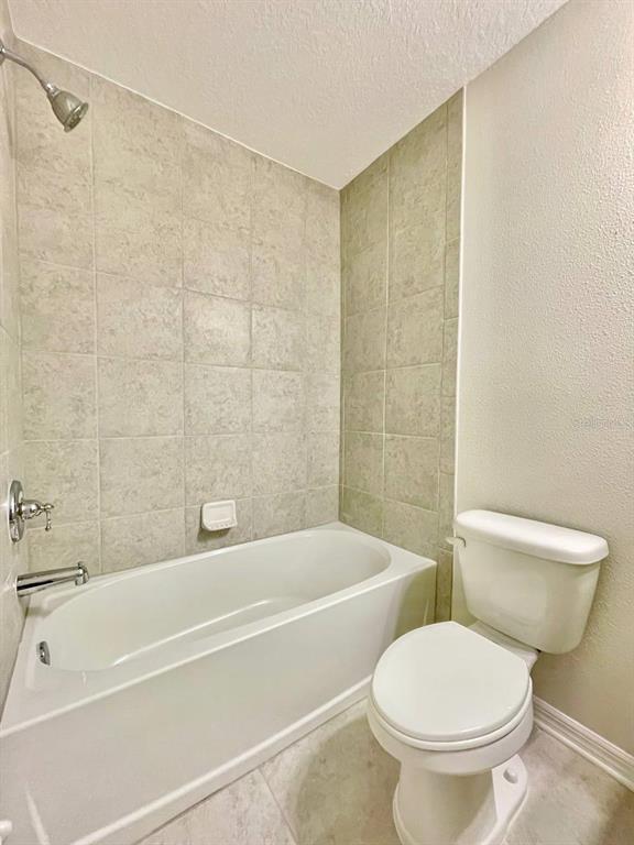 9689 Sweetwell Place Riverview, FL 33569 - Photo 24 of 33 a bathroom with a toilet and a bath tub