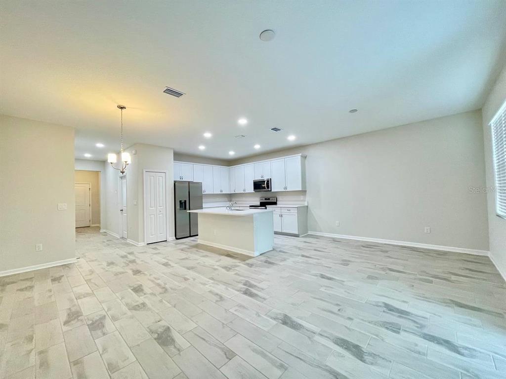 9689 Sweetwell Place Riverview, FL 33569 - Photo 4 of 33 a view of kitchen with kitchen island white cabinets appliances and a fireplace