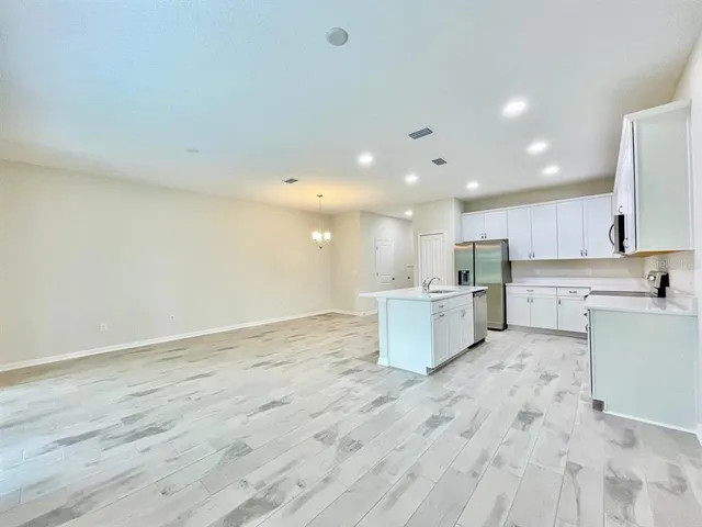 a view of kitchen with wooden floor and electronic appliances
