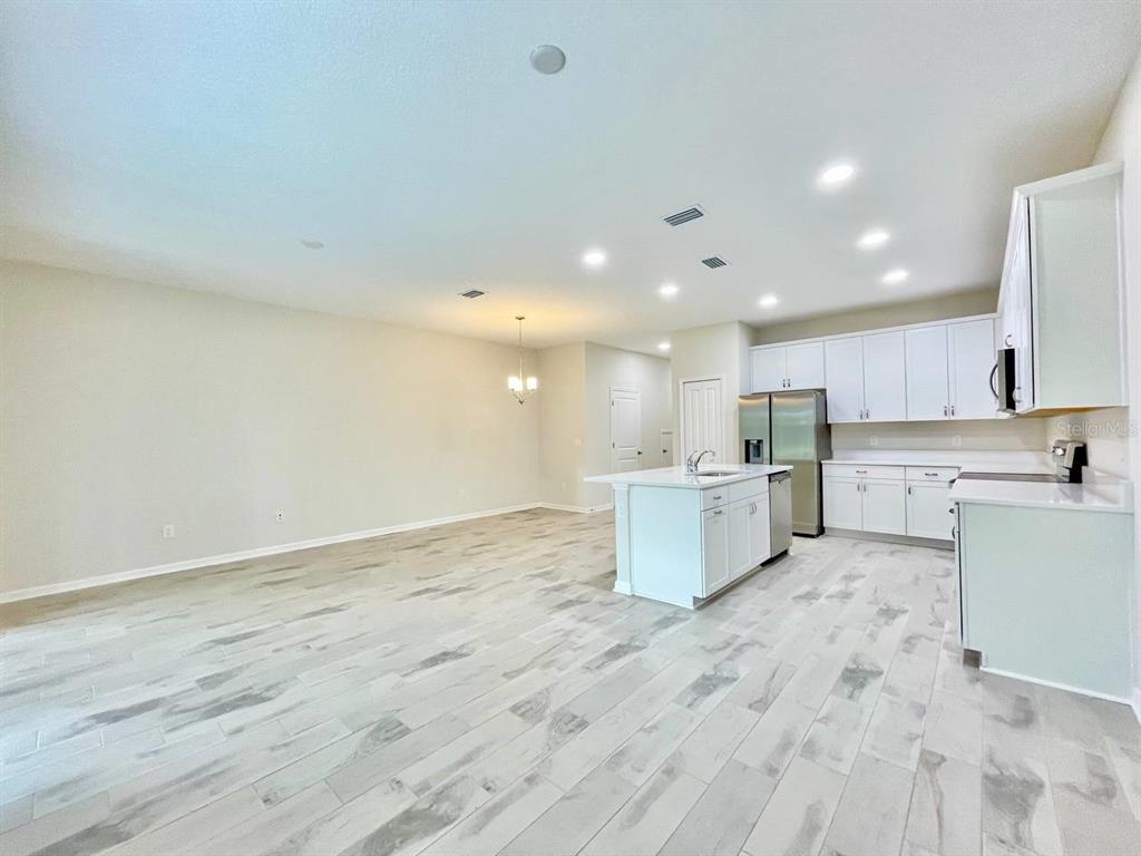 9689 Sweetwell Place Riverview, FL 33569 - Photo 6 of 33 a view of kitchen with wooden floor and electronic appliances
