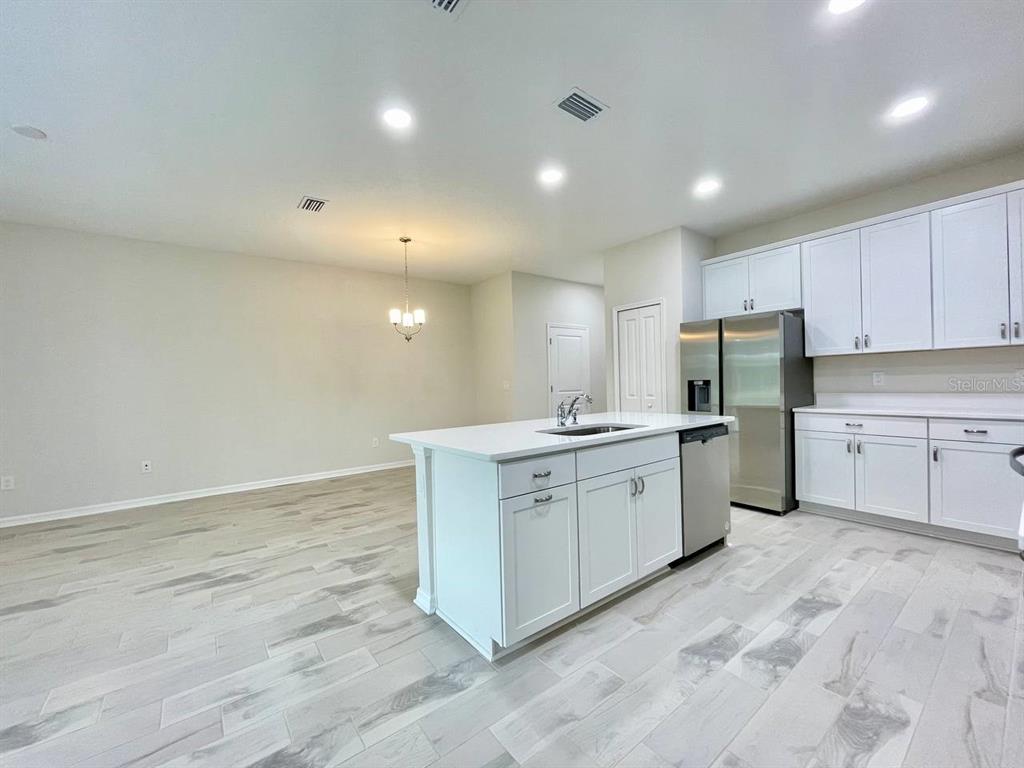 9689 Sweetwell Place Riverview, FL 33569 - Photo 7 of 33 a large white kitchen with cabinets
