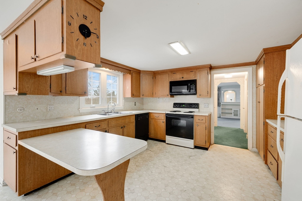 48 Murphy Road Hyannis, MA 02601 - Photo 12 of 31 a kitchen with stainless steel appliances granite countertop a sink a stove and a refrigerator
