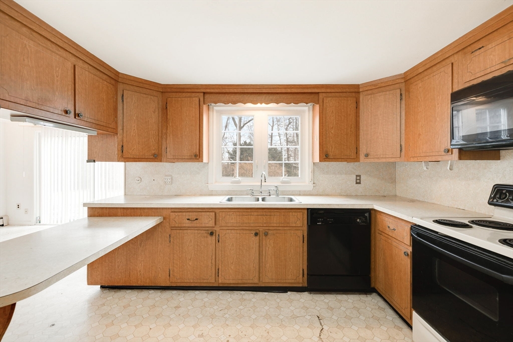 48 Murphy Road Hyannis, MA 02601 - Photo 13 of 31 a kitchen with stainless steel appliances granite countertop a sink and a stove