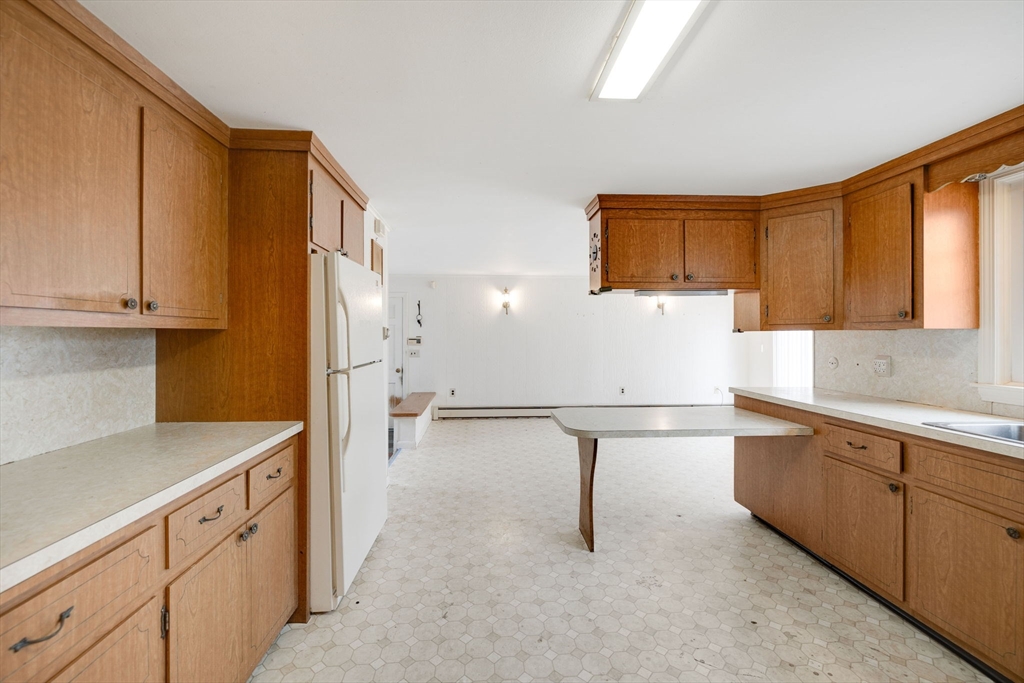 48 Murphy Road Hyannis, MA 02601 - Photo 14 of 31 a kitchen with a refrigerator and white cabinets