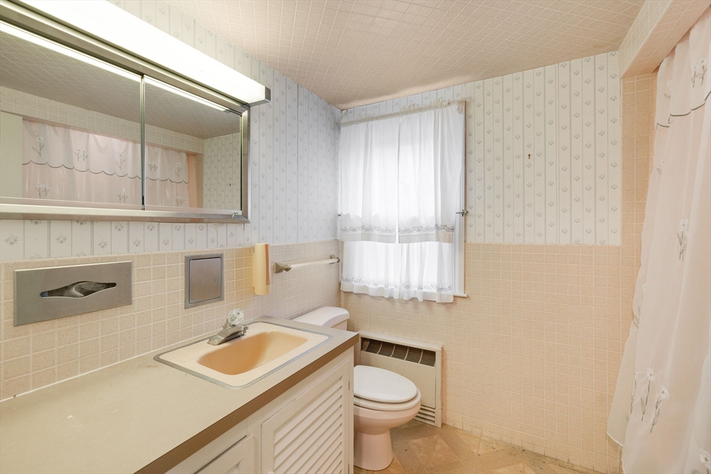 48 Murphy Road Hyannis, MA 02601 - Photo 21 of 31 a bathroom with a sink toilet and window