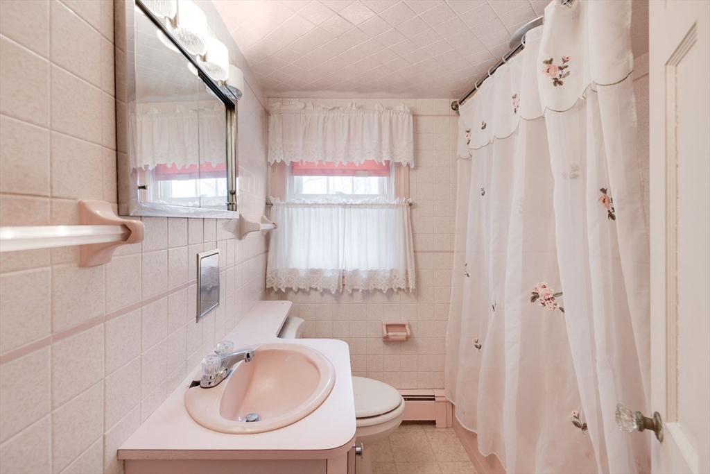 48 Murphy Road Hyannis, MA 02601 - Photo 22 of 31 a bathroom with a sink a toilet and shower curtain