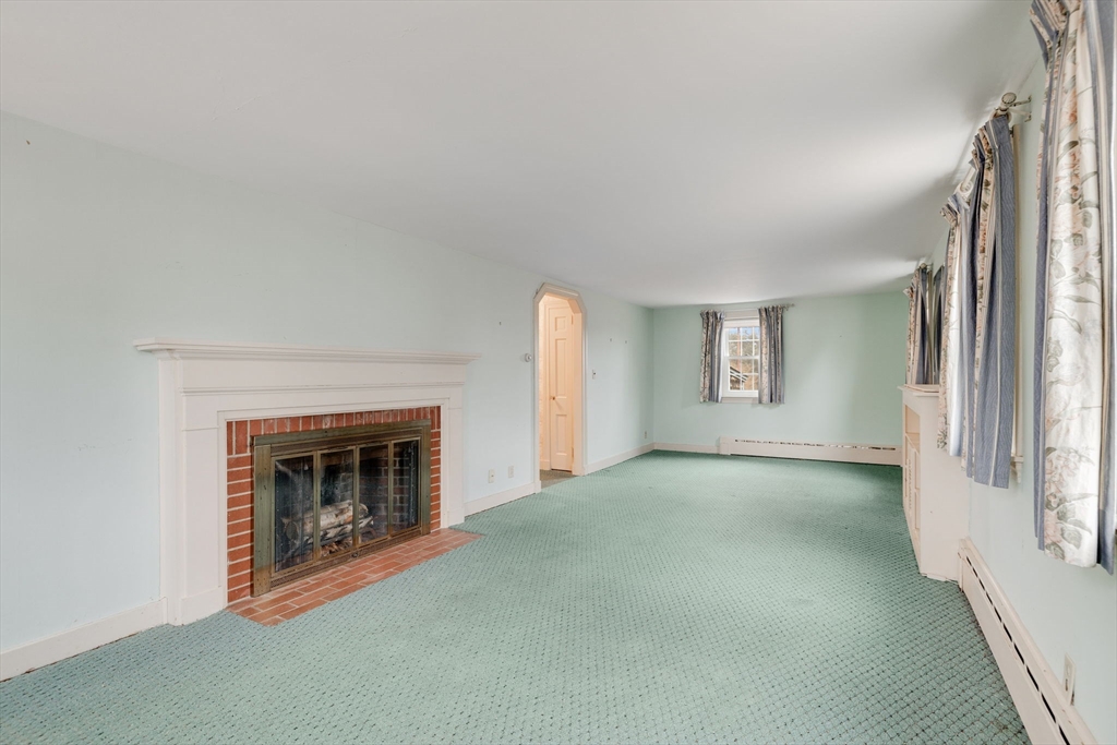 48 Murphy Road Hyannis, MA 02601 - Photo 5 of 31 an empty room with fireplace and window