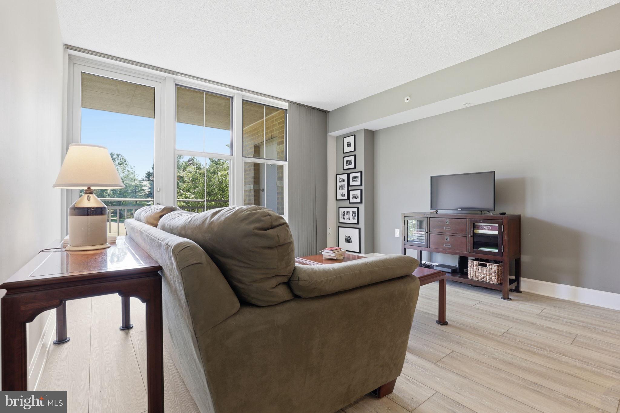 11800 Sunset Hills Road, Unit 218 Reston, VA 20190 - Photo 15 of 38 a living room with furniture and a window