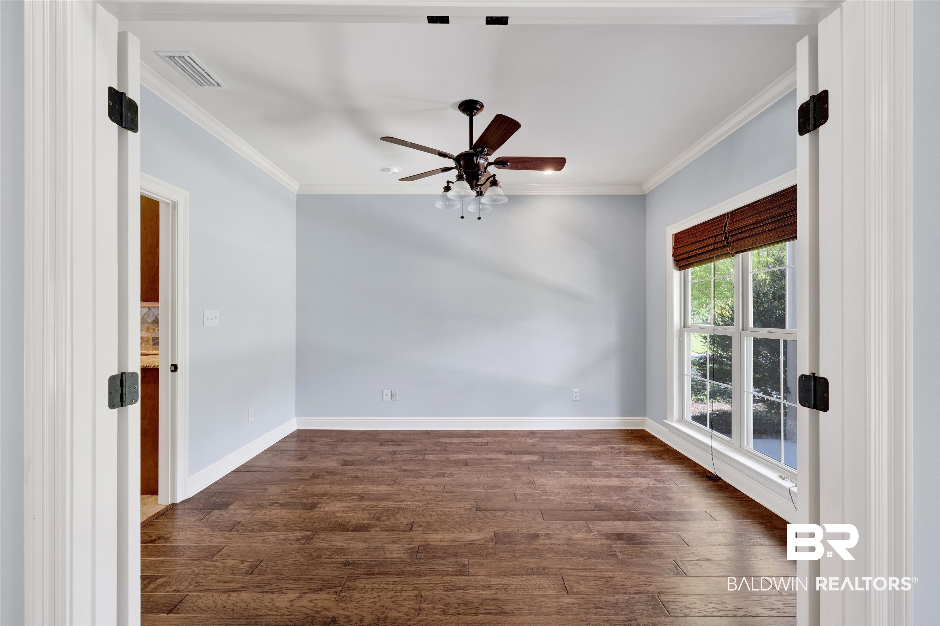 12944 Anna's Way Stapleton, AL 36578 - Photo 46 of 64 Room featuring wood-finish flooring, light blue walls, and white crown molding