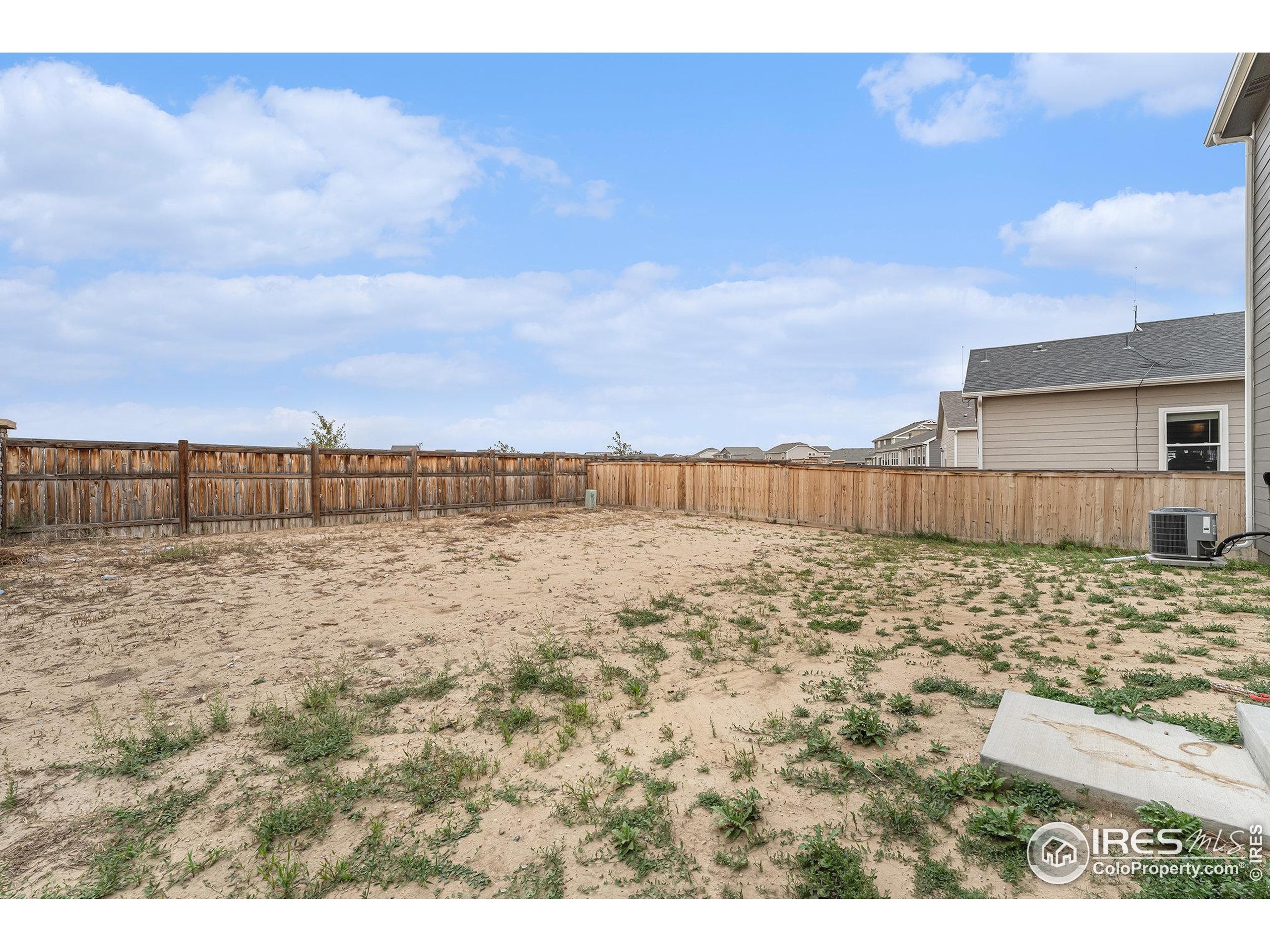 971 Ouzel Falls Road Severance, CO 80550 - Photo 15 of 16 a view of a dry yard with wooden fence