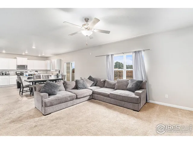 a living room with furniture and kitchen view
