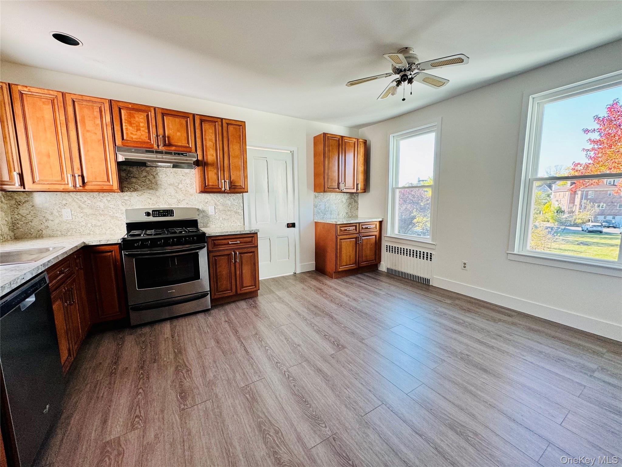 a kitchen with stainless steel appliances a stove a sink dishwasher and a refrigerator