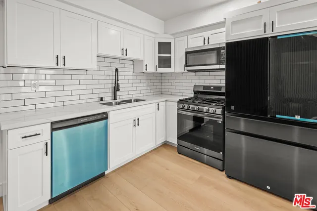 a kitchen with a sink stove and refrigerator