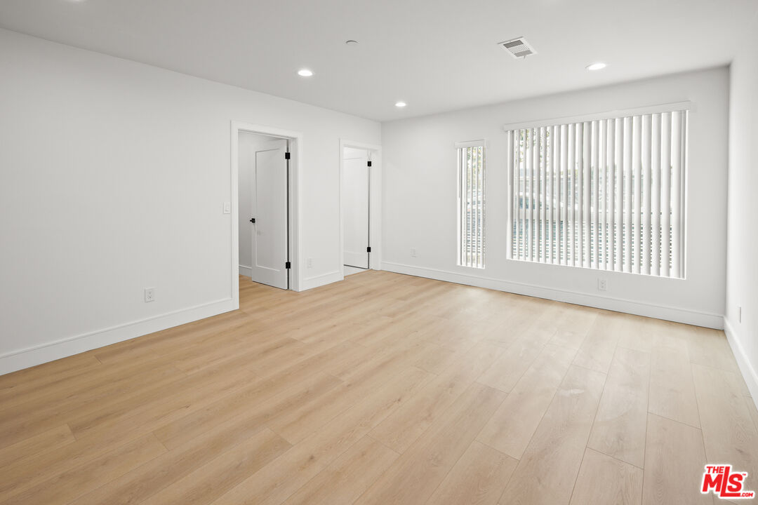 2700 Fletcher Drive, Unit A Los Angeles, CA 90039 - Photo 16 of 33 an empty room with wooden floor and windows