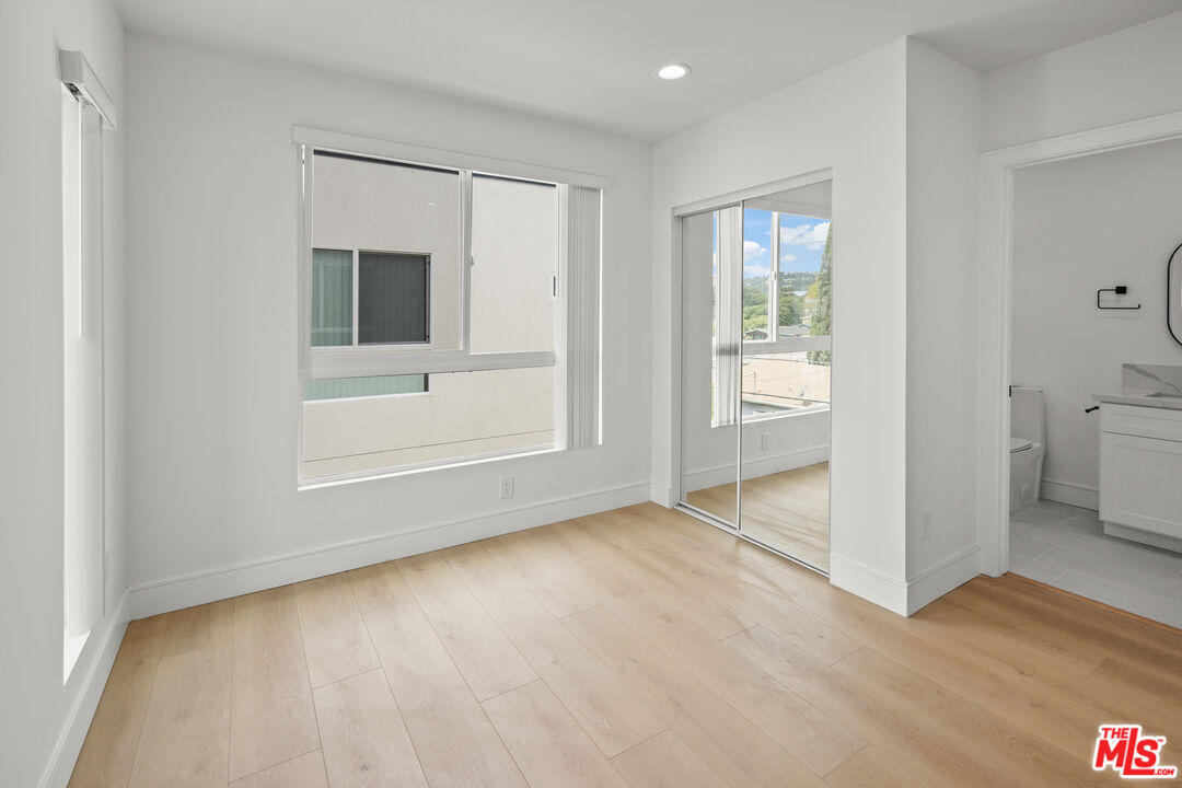2700 Fletcher Drive, Unit A Los Angeles, CA 90039 - Photo 21 of 33 a view of an empty room with a window and wooden floor