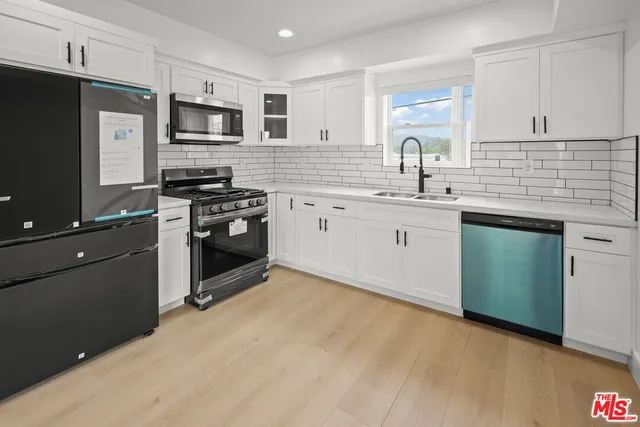 a kitchen with a sink stove and refrigerator