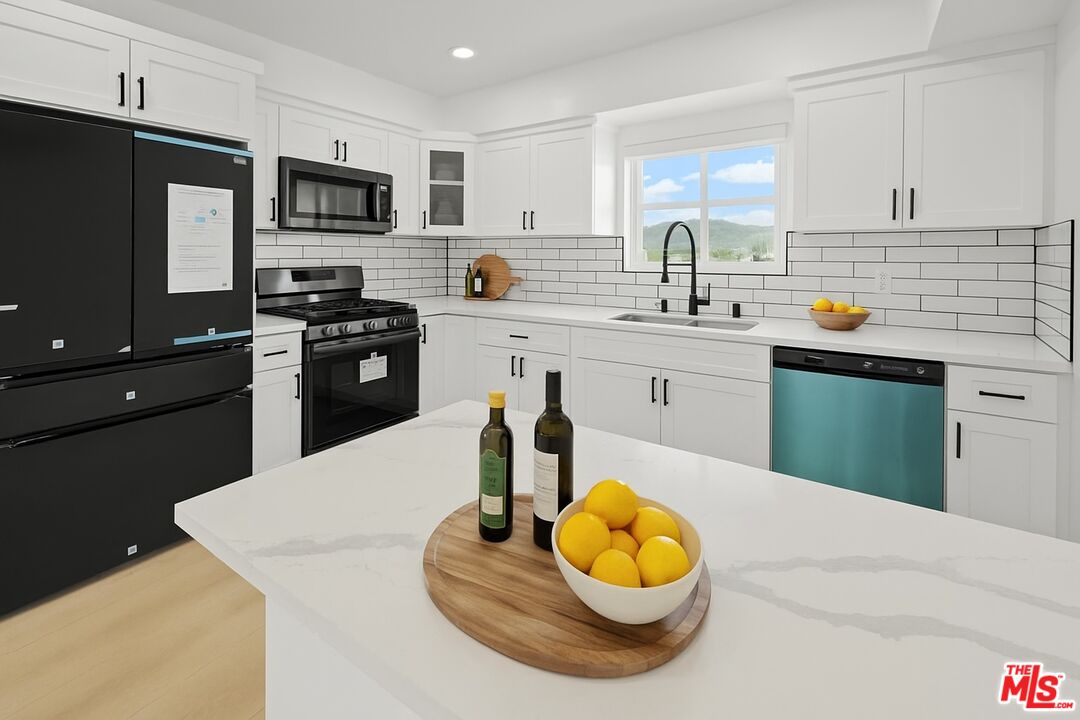 2700 Fletcher Drive, Unit A Los Angeles, CA 90039 - Photo 4 of 33 a kitchen with stainless steel appliances a sink a microwave a refrigerator and cabinets