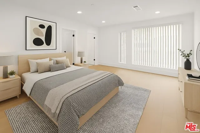 a bedroom with a large bed and a window