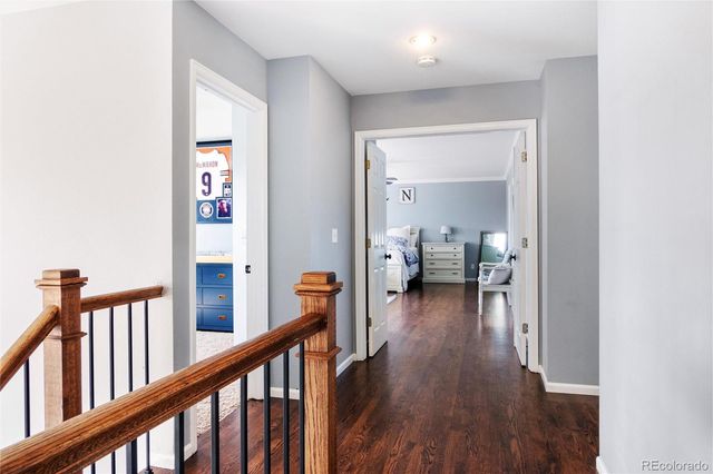 a spacious bedroom with a bed and wooden floor