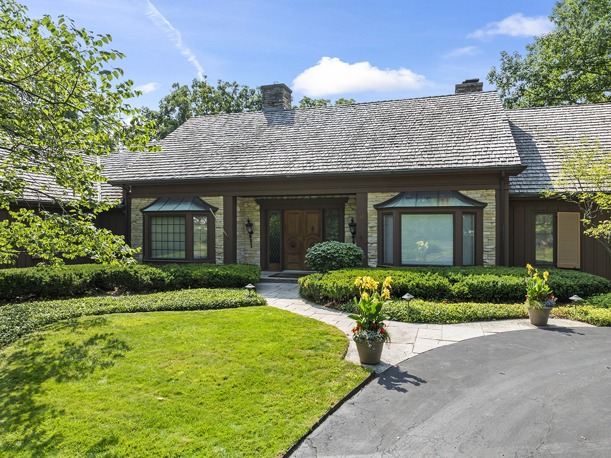 1931 Camphill Circle Inverness, IL 60067 - Photo 2 of 55 a front view of a house with a yard and outdoor seating
