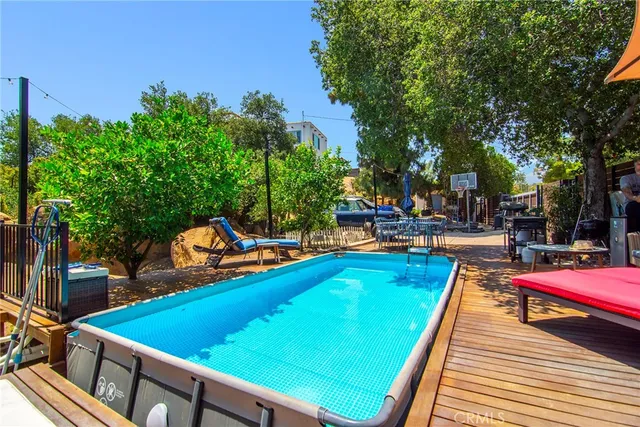 a view of a backyard with table and chairs under an umbrella