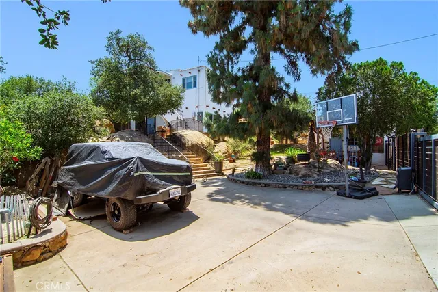a view of a patio with table and chairs and potted plants