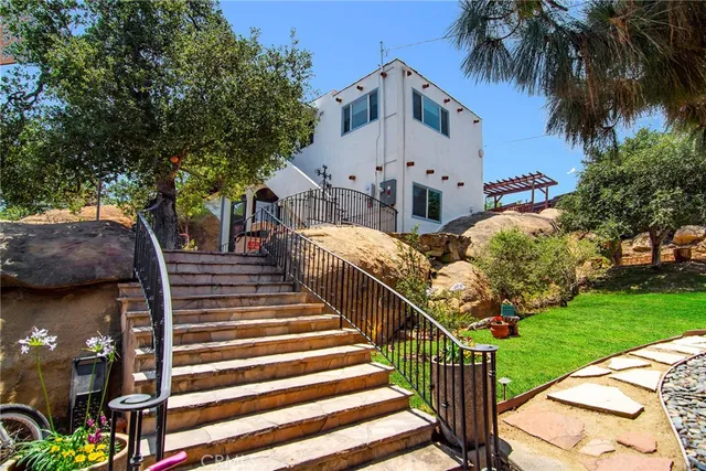 a view of a house with a flower garden