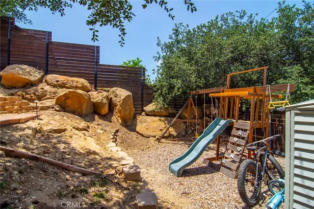 a bedroom with a bed window and a dresser