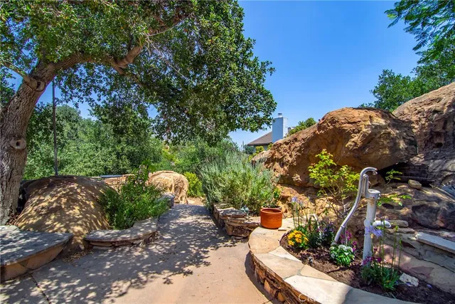 a living room with fireplace furniture and a large window