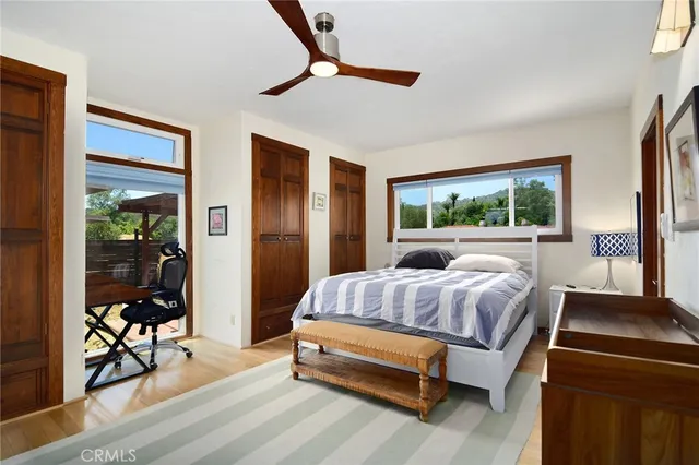 a living room with furniture large window and flat screen tv