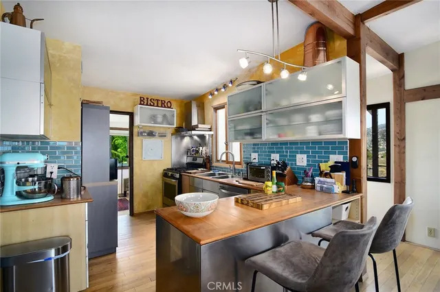 a view of a balcony with chairs and wooden floor