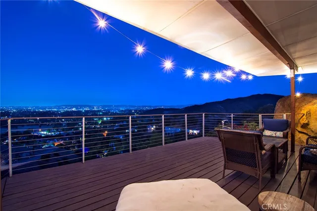 a view of a swimming pool with chairs in patio