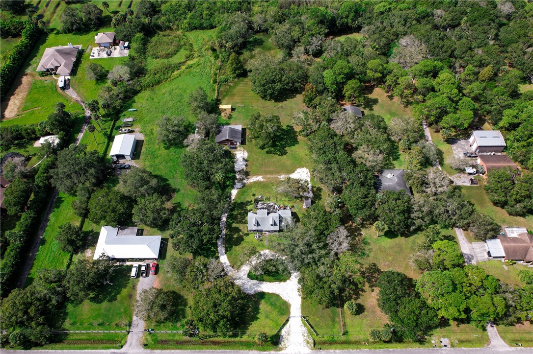 4761 Jorgensen Road Fort Pierce, FL 34981 - Photo 12 of 26 an aerial view of residential house with outdoor space and trees all around