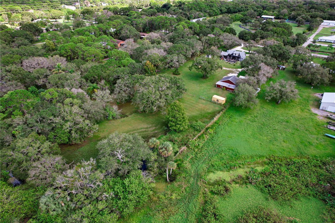 4761 Jorgensen Road Fort Pierce, FL 34981 - Photo 15 of 26 an aerial view of residential house with outdoor space and trees all around