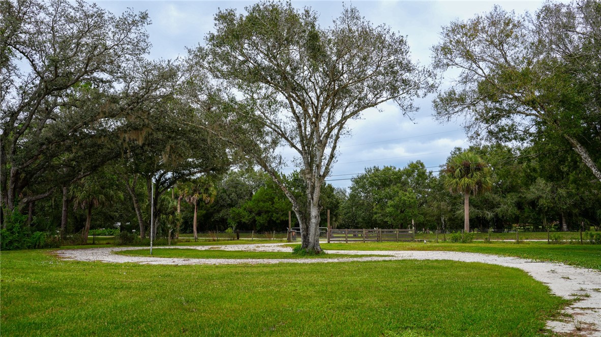 4761 Jorgensen Road Fort Pierce, FL 34981 - Photo 23 of 26 a backyard of a house with lots of green space and fountain