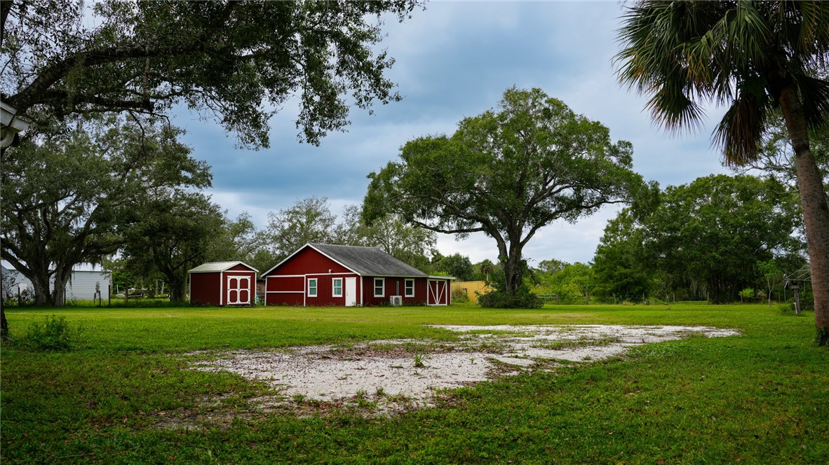 4761 Jorgensen Road Fort Pierce, FL 34981 - Photo 7 of 26 a view of a house with a big yard