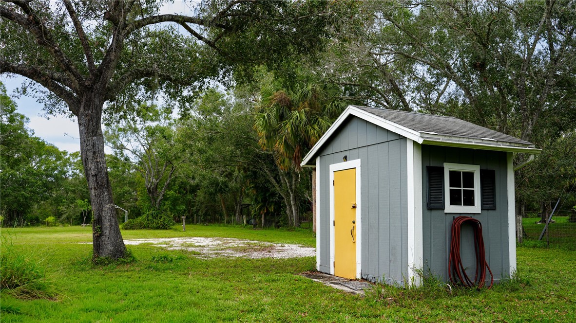 4761 Jorgensen Road Fort Pierce, FL 34981 - Photo 9 of 26 a house with a tree in front of it