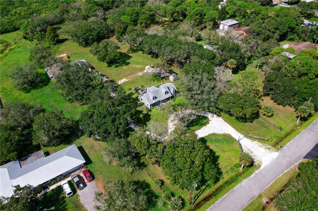 4761 Jorgensen Road Fort Pierce, FL 34981 - Photo 10 of 26 an aerial view of residential house with outdoor space and trees all around