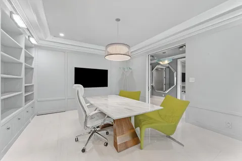 a dining room with furniture a large window and kitchen view