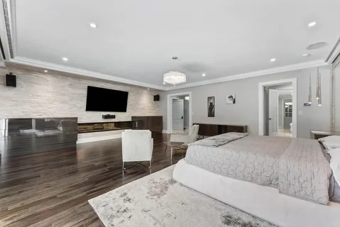 a kitchen with white cabinets and sink