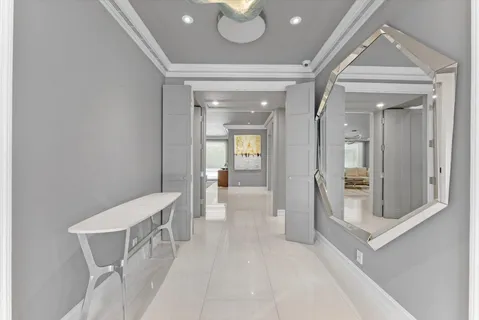 a view of a dining room with furniture and a chandelier