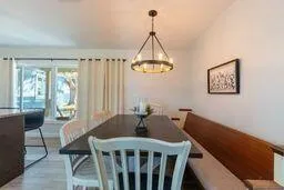 a dining room with furniture and wooden floor