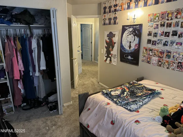 a bedroom with a bed and a television