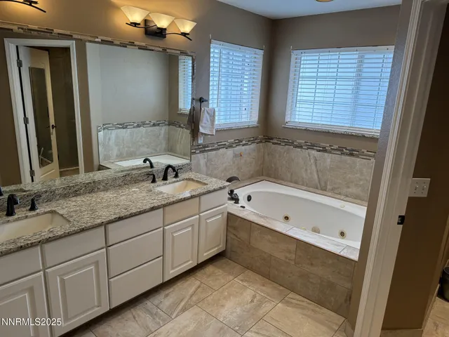 a view of a patio with table and chairs potted plants and a large tree
