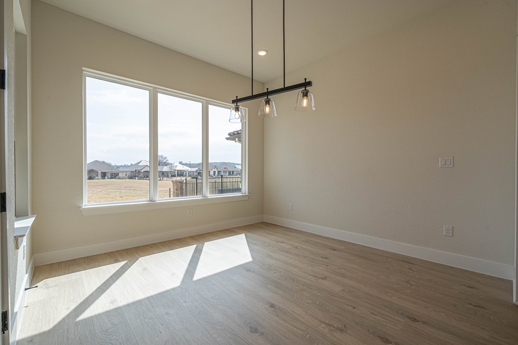 2013 Toscano Way Kerrville, TX 78028 - Photo 11 of 17 a view of an empty room with a window and wooden floor