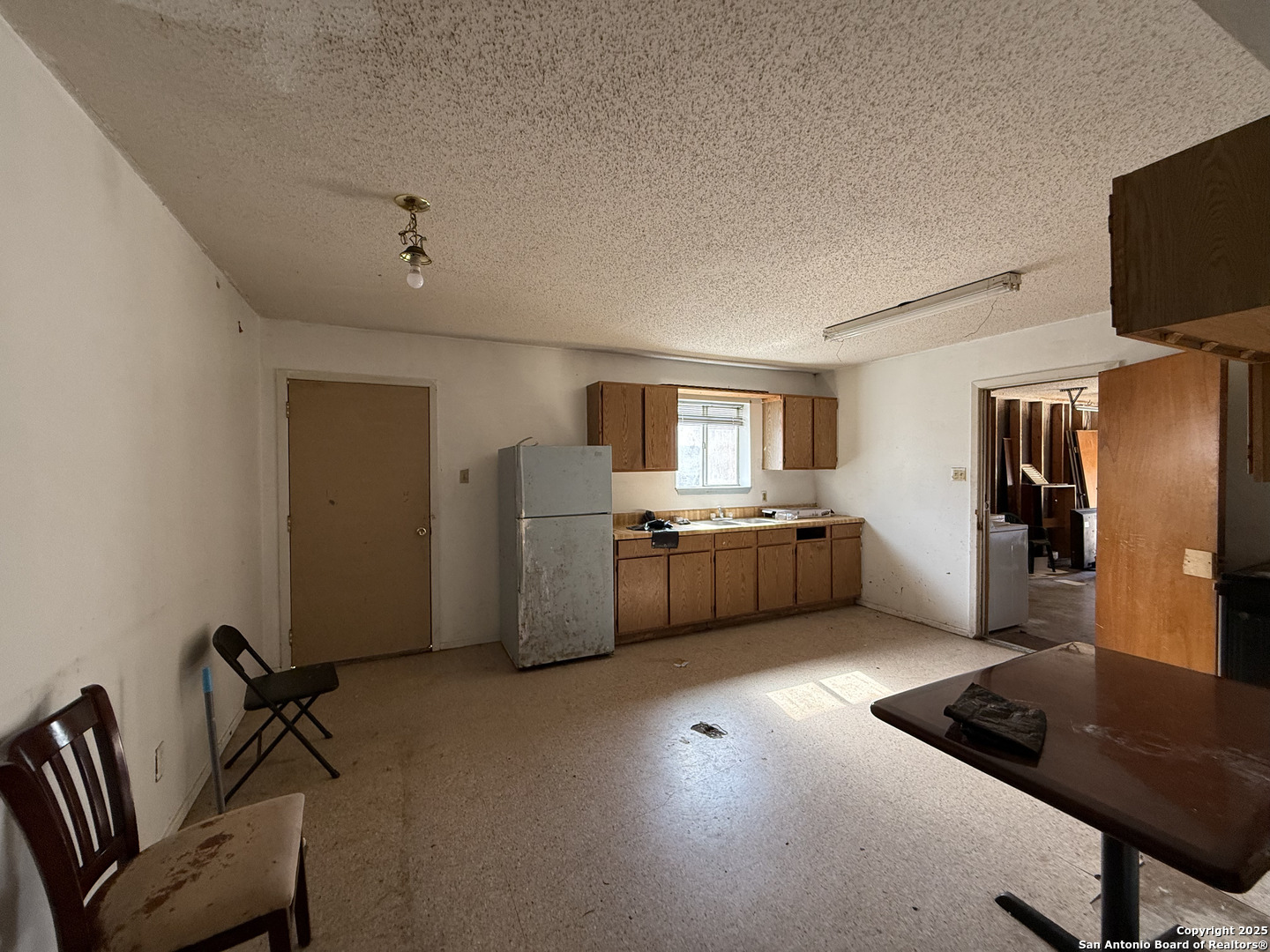 813 Ross Street Kerrville, TX 78028 - Photo 4 of 12 a kitchen with stainless steel appliances a refrigerator and a stove top oven