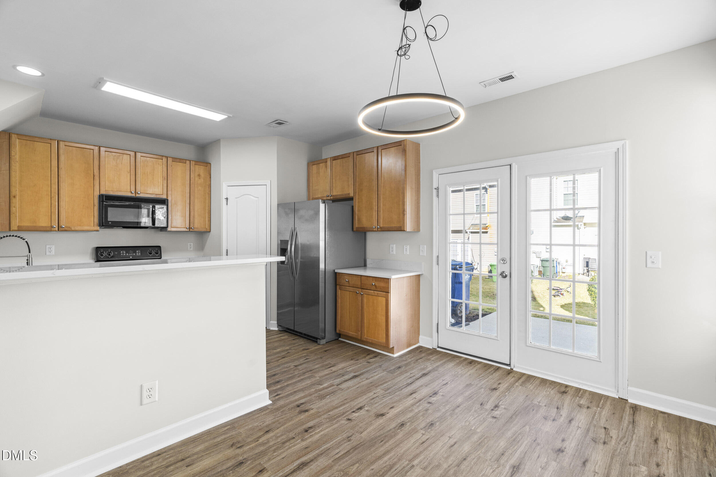 8320 Boca Point Raleigh, NC 27616 - Photo 12 of 28 a kitchen with stainless steel appliances a refrigerator a stove a sink cabinets and wooden floor