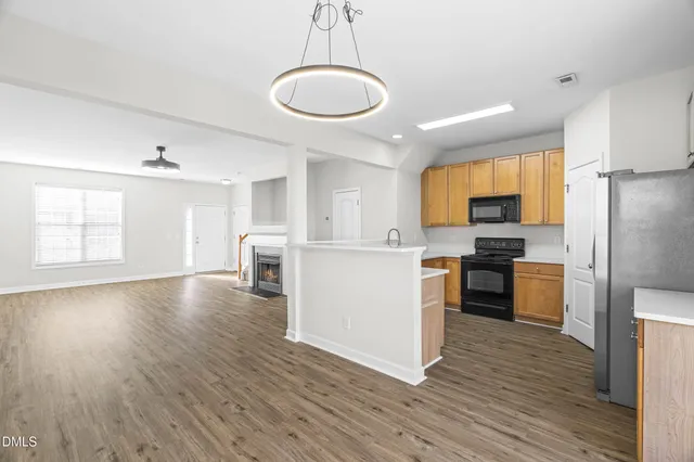 a kitchen with a refrigerator and a stove top oven